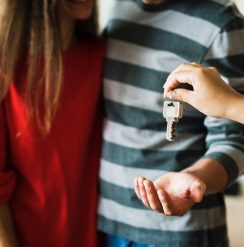 house keys being handed over to young couple